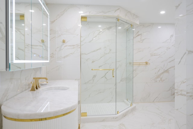 bathroom with tile walls, an enclosed shower, vanity, and tile flooring