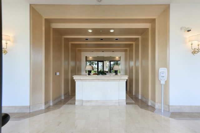 interior space with light tile floors and beam ceiling