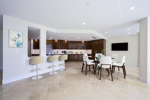 dining area with light tile floors and sink