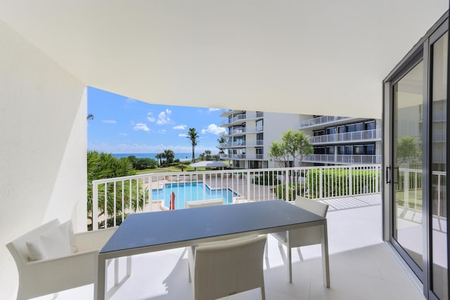 balcony featuring a community pool