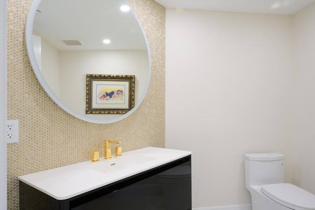 bathroom featuring toilet and vanity