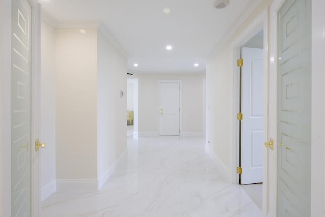 hallway featuring crown molding and light tile floors