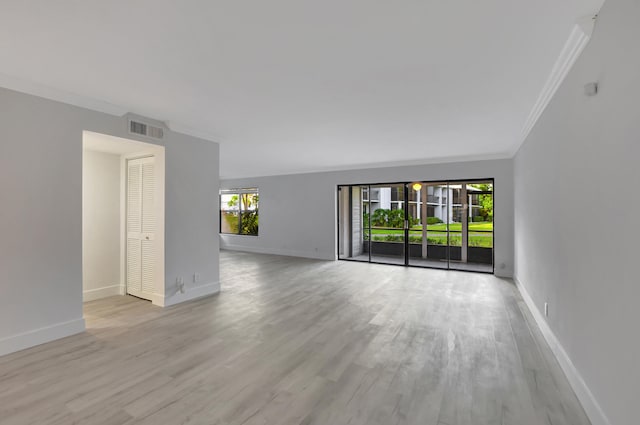 spare room with crown molding and light hardwood / wood-style flooring