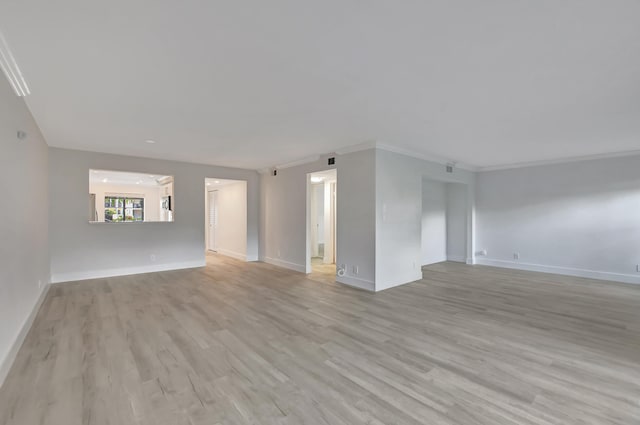 spare room with light hardwood / wood-style floors and ornamental molding