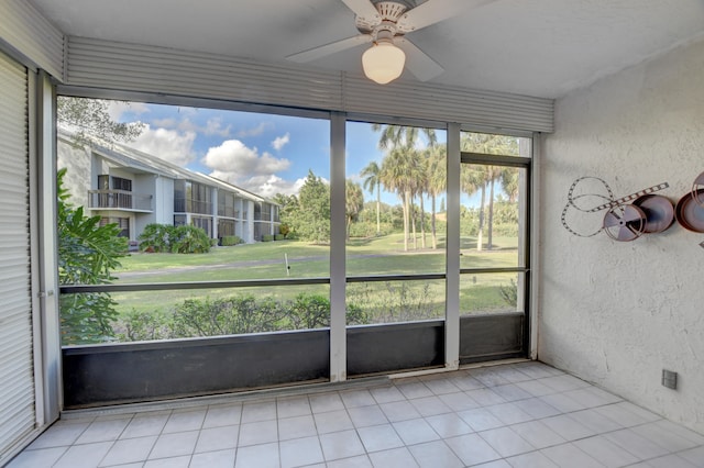 unfurnished sunroom with plenty of natural light and ceiling fan