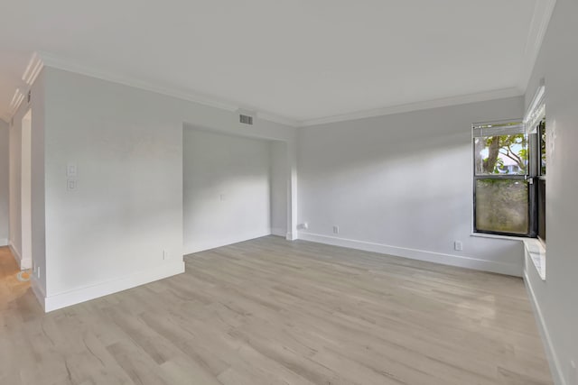 spare room featuring light hardwood / wood-style floors and ornamental molding