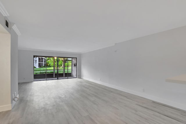 empty room featuring crown molding and light hardwood / wood-style flooring