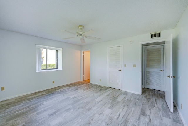 unfurnished bedroom with light hardwood / wood-style floors and ceiling fan