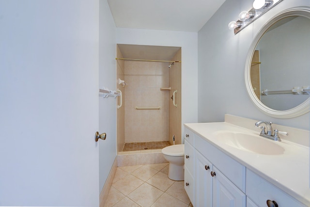 bathroom with toilet, vanity with extensive cabinet space, tile floors, and a tile shower