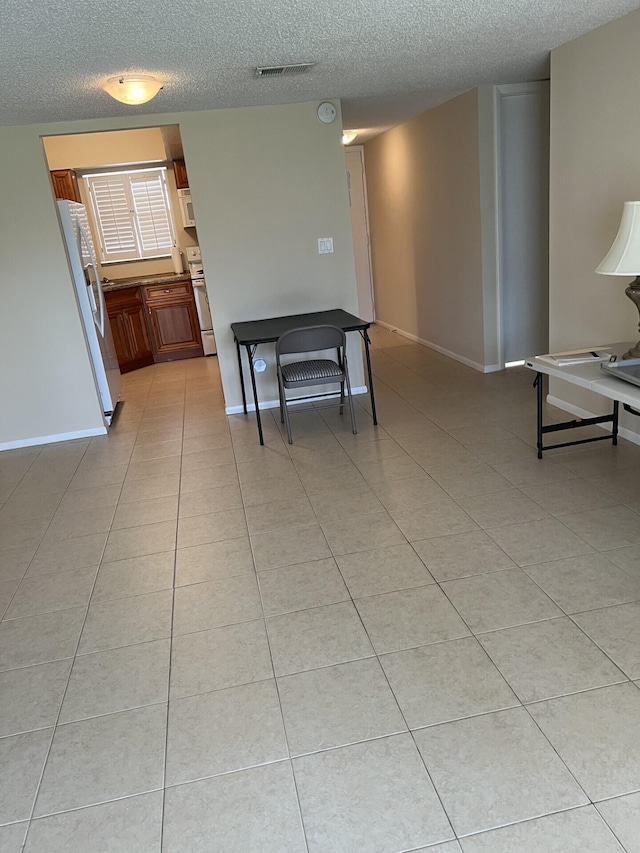 interior space featuring tile flooring and a textured ceiling