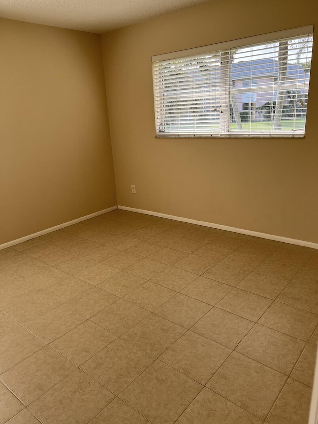 spare room with light tile floors