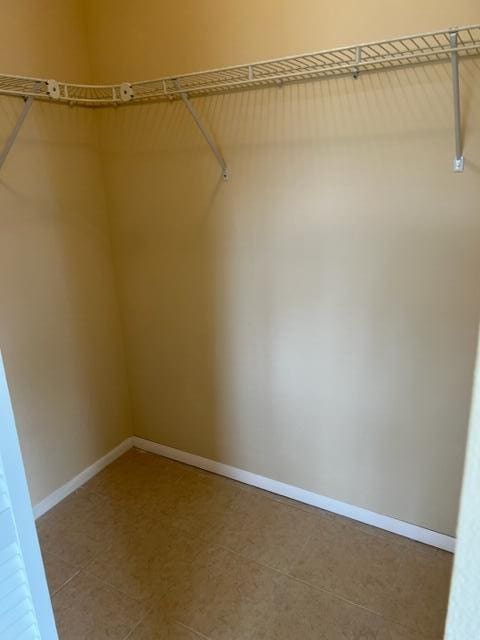 spacious closet featuring light tile floors