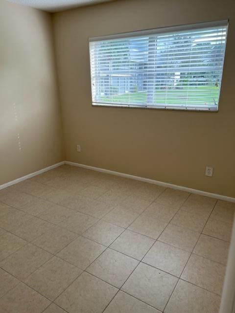 spare room with light tile floors