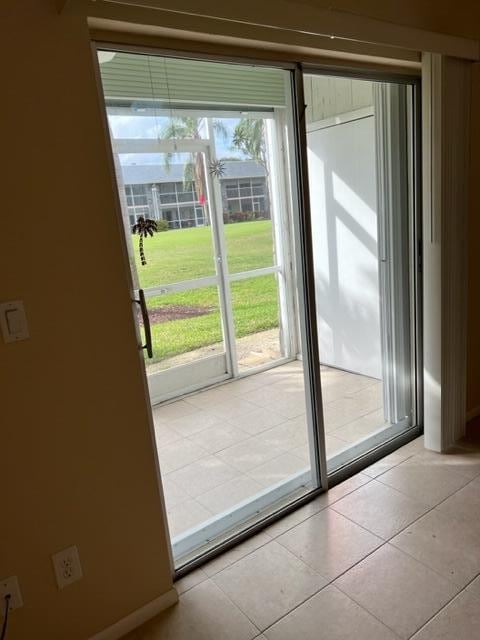 entryway featuring light tile flooring and a wealth of natural light