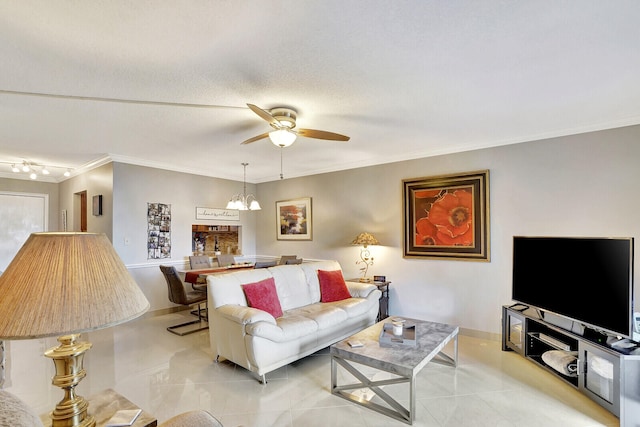 tiled living room with crown molding, rail lighting, a textured ceiling, and ceiling fan with notable chandelier