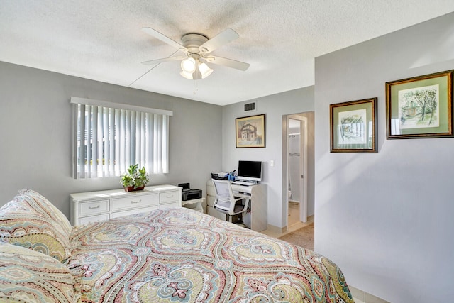 carpeted bedroom with ceiling fan and a textured ceiling