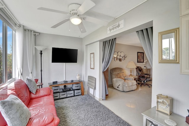 living room with tile floors and ceiling fan