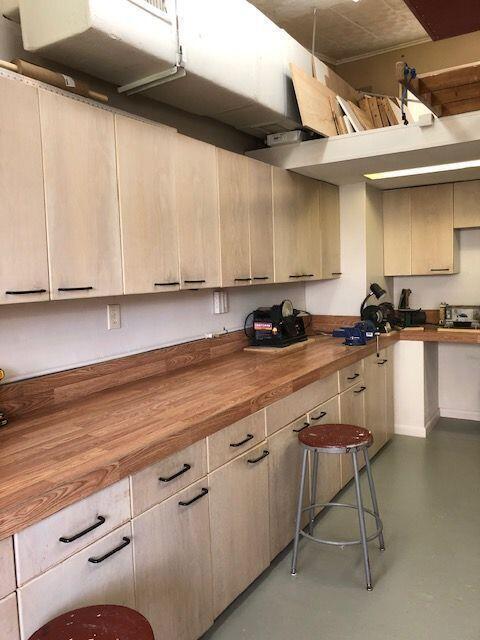 kitchen with concrete flooring, light brown cabinets, and butcher block counters