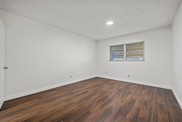 empty room featuring dark hardwood / wood-style floors