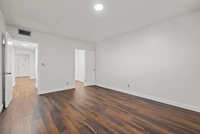 unfurnished room with dark hardwood / wood-style floors