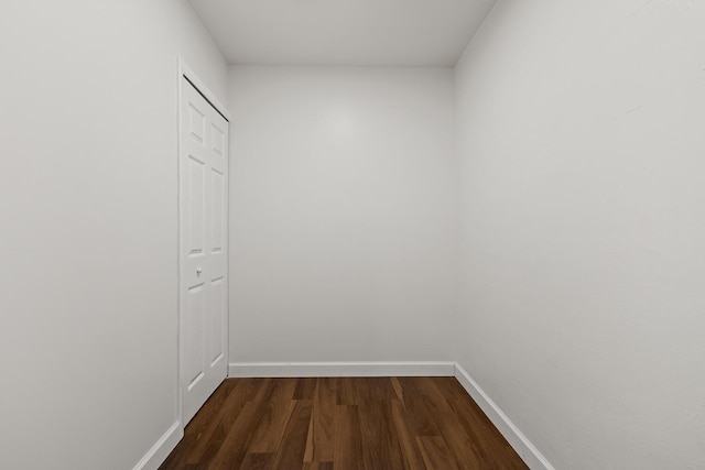 corridor featuring dark wood-type flooring