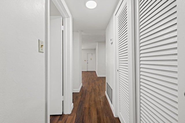 hallway with dark hardwood / wood-style flooring