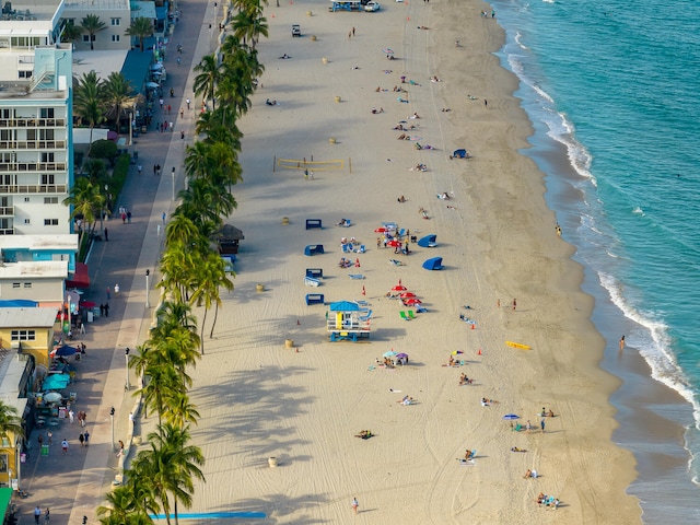 drone / aerial view with a water view and a beach view