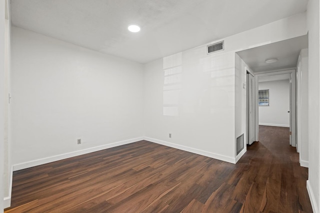 empty room with dark hardwood / wood-style floors