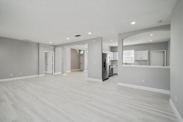 unfurnished living room with light wood-type flooring