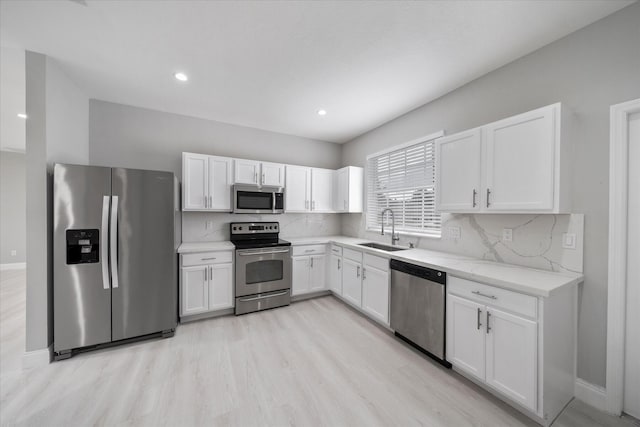 kitchen with white cabinets, sink, and stainless steel appliances