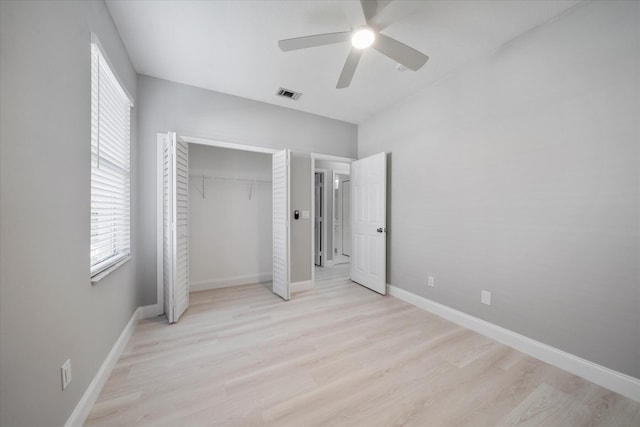 unfurnished bedroom featuring a closet, ceiling fan, and light wood-type flooring