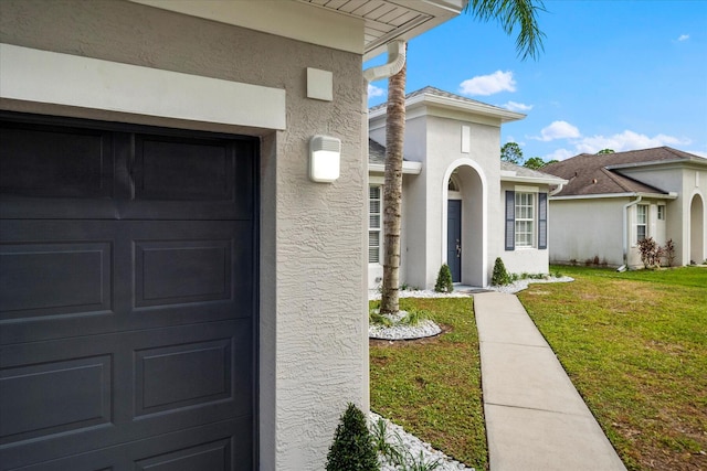 doorway to property with a lawn