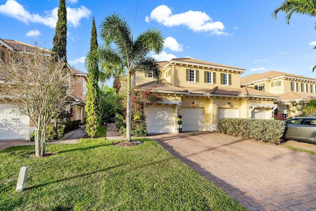 view of front of property with a front yard and a garage