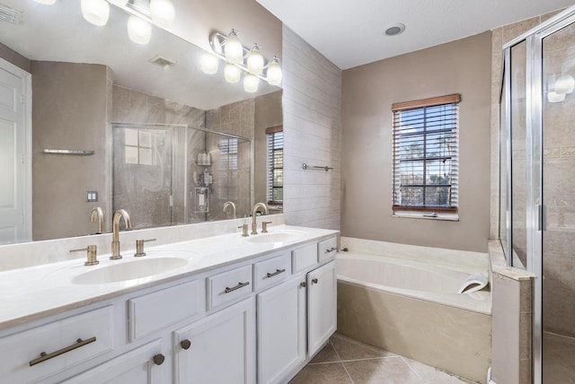 bathroom with shower with separate bathtub, dual sinks, large vanity, and tile flooring