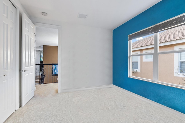 unfurnished bedroom featuring light carpet