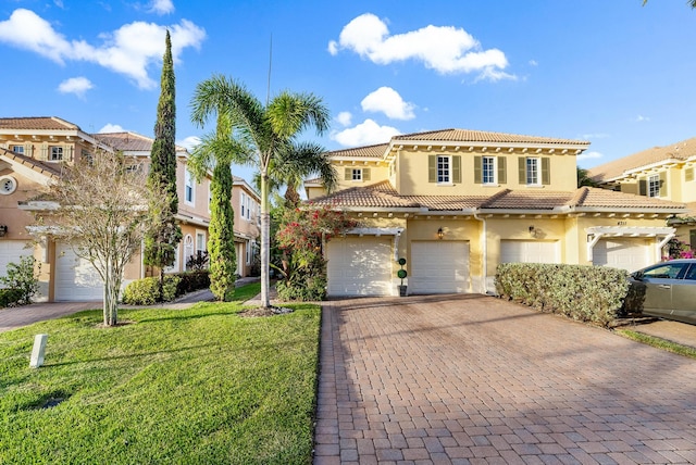 mediterranean / spanish-style home with a front lawn and a garage