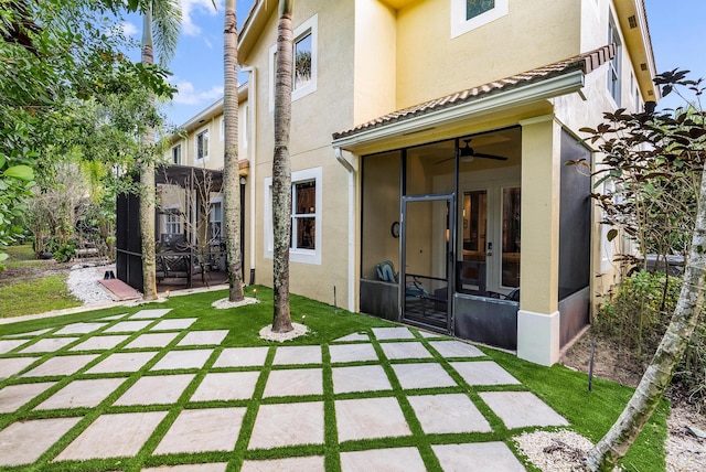 back of house with a yard, ceiling fan, and a patio