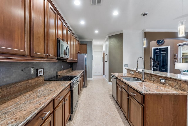 kitchen featuring crown molding, hanging light fixtures, stainless steel appliances, and sink