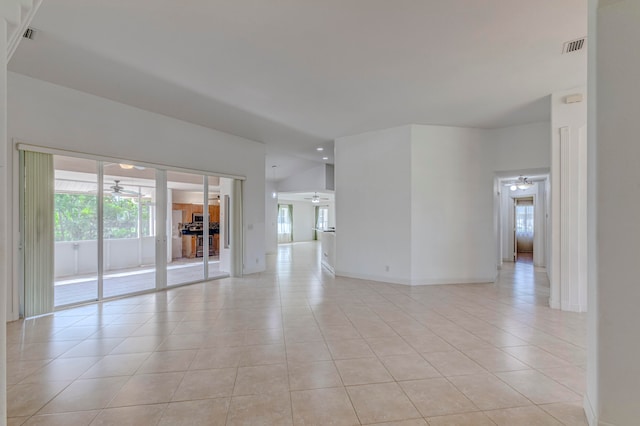 spare room with ceiling fan and light tile floors