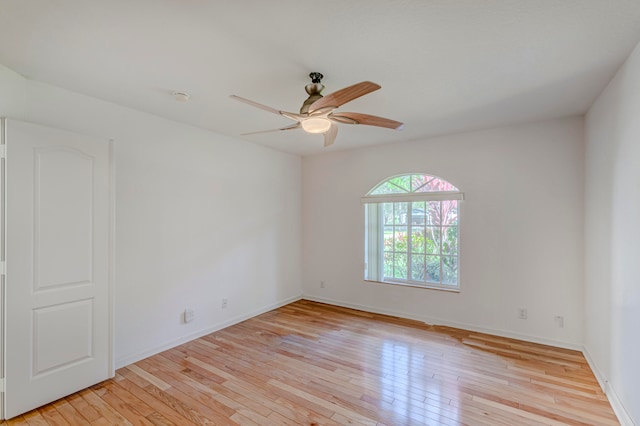 spare room with ceiling fan and light wood-type flooring