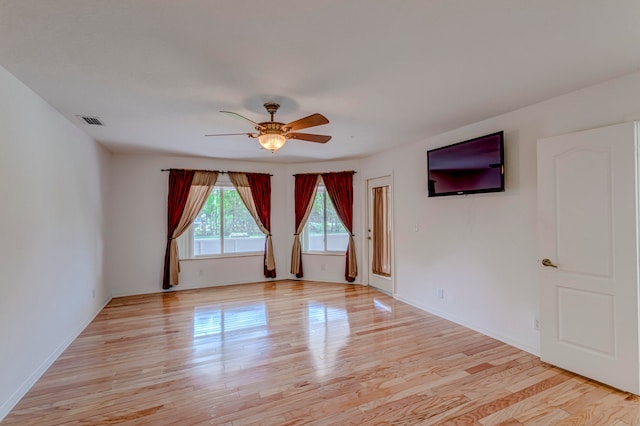 empty room with light hardwood / wood-style flooring and ceiling fan