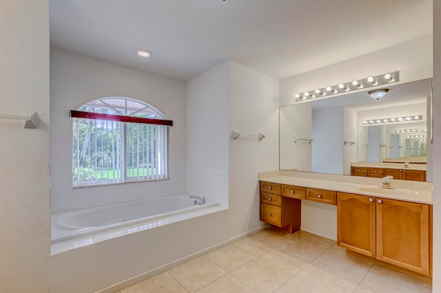 bathroom with tiled tub, tile flooring, and vanity