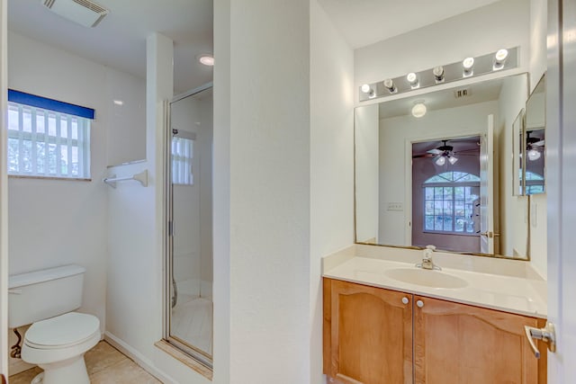 bathroom with tile flooring, ceiling fan, a shower with door, toilet, and vanity