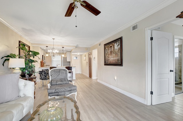 living room featuring crown molding, ceiling fan with notable chandelier, sink, and light wood-type flooring