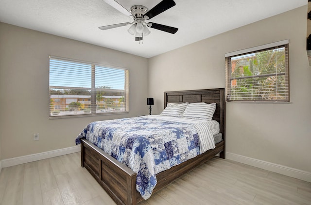 bedroom featuring ceiling fan and light hardwood / wood-style flooring