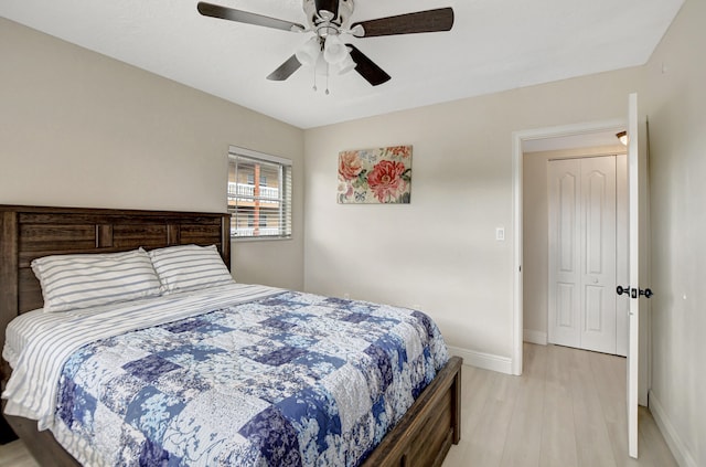 bedroom with a closet, ceiling fan, and light wood-type flooring