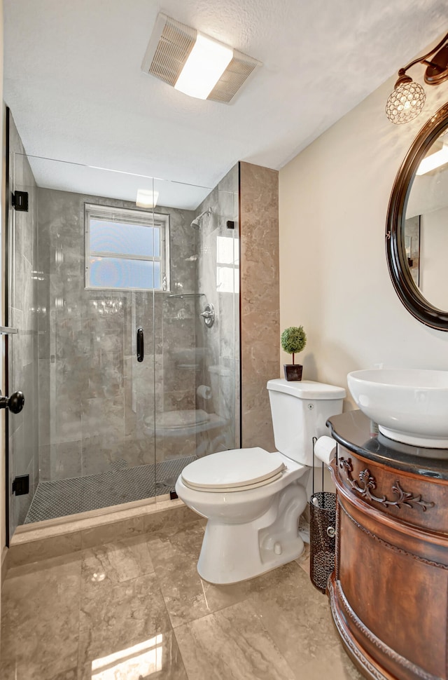 bathroom featuring an enclosed shower, toilet, vanity, and tile flooring