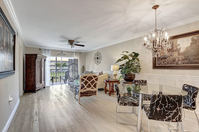 dining space featuring a textured ceiling, light hardwood / wood-style floors, ornamental molding, and ceiling fan with notable chandelier