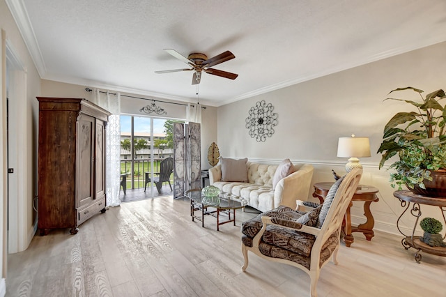 sitting room with crown molding, light hardwood / wood-style floors, and ceiling fan