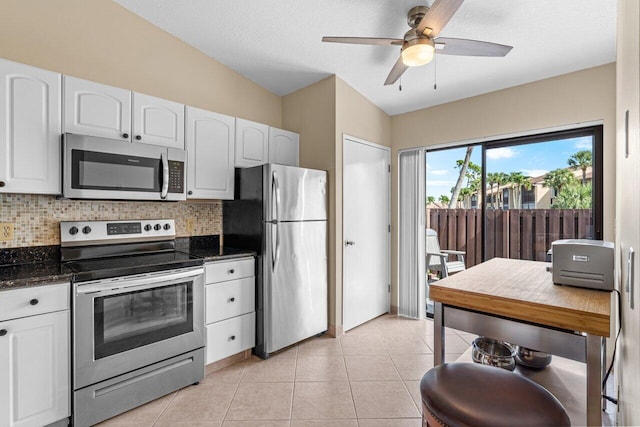 kitchen with appliances with stainless steel finishes, ceiling fan, tasteful backsplash, and white cabinets